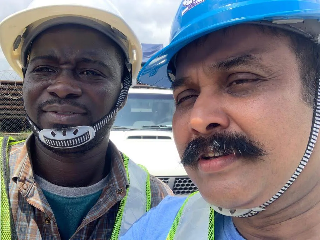 Two of the crew at Tema, hard hats on before the morning landing
