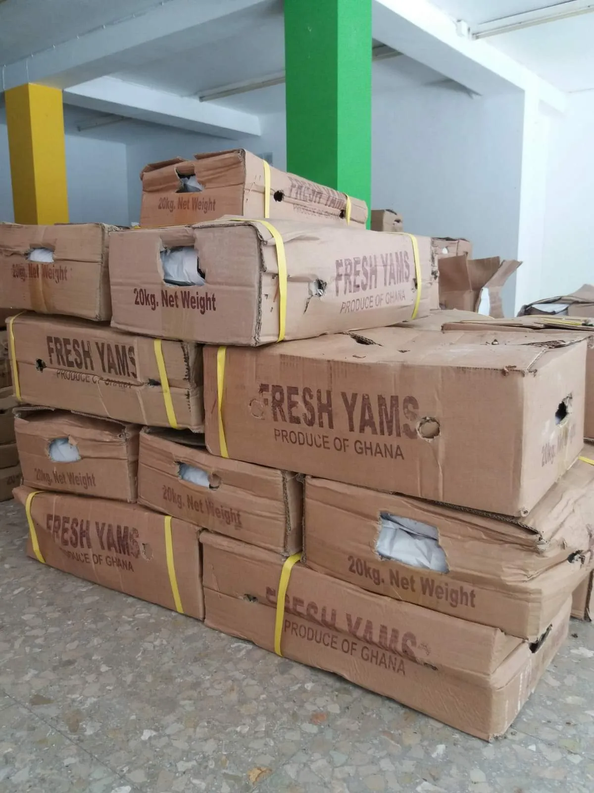 Cartons of fresh yams marked Produce of Ghana ready for export