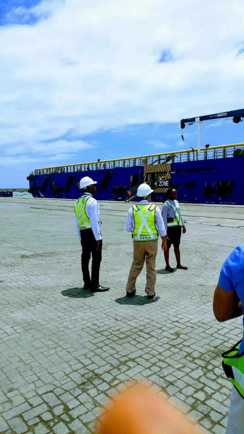 Port staff on the quay beside a docked vessel