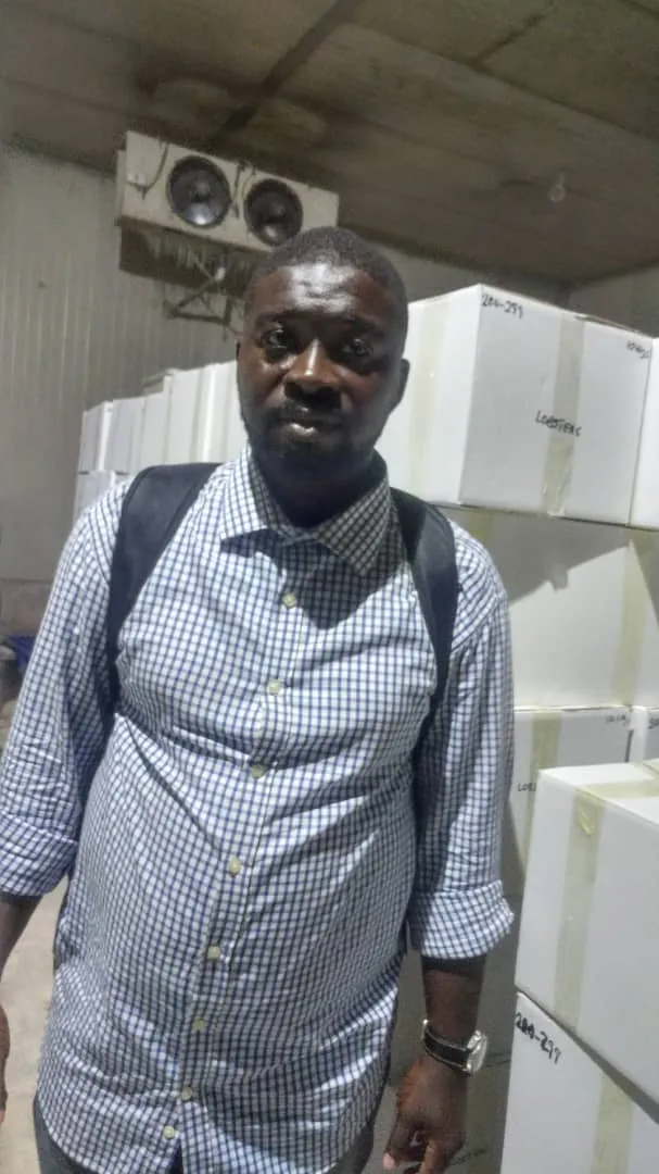 Zroni's founder in the cold room with export lobster boxes